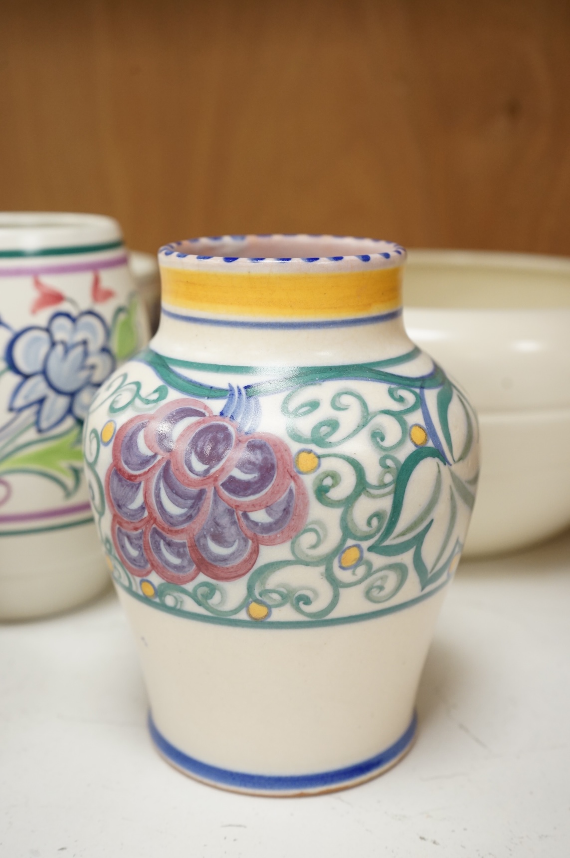 A collection of eight Poole pottery pieces to include vases, bowls and a jar and cover, largest 28cm in diameter